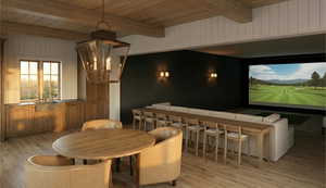 Dining space featuring light wood-type flooring, wood walls, and a wood ceiling with exposed beams