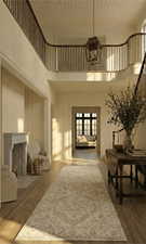 Entryway with dark wood-type flooring, a fireplace, suspended lighting, and a high wood ceiling