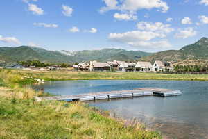 Dock area with a water and mountain view
