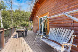 Wooden terrace featuring outdoor dining area