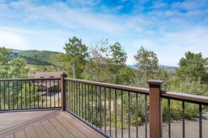 Wooden deck featuring a wooded view