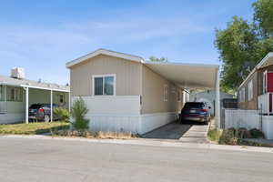 Manufactured / mobile home with a carport and driveway