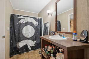 Full bathroom featuring crown molding, tile patterned flooring, vanity, and a shower with shower curtain