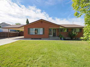 View of front facade featuring a carport, brick siding, and concrete driveway