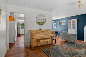 Living area featuring a textured ceiling and wood finished floors