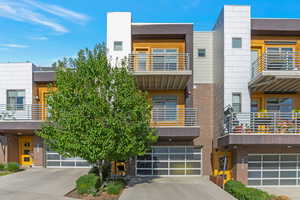 View of building exterior with a garage and driveway