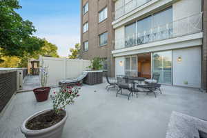 View of patio / terrace featuring outdoor dining space with the exclusive gate open to the pool and BBQ area.