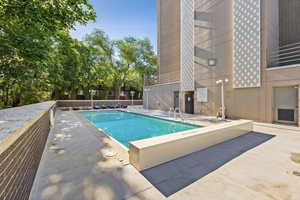 Community pool with a patio area