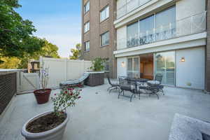 View of patio featuring outdoor dining space and a gate