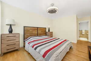 Bedroom featuring light wood finished floors and baseboards