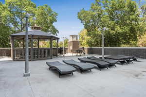 View of patio with a gazebo and area for grilling