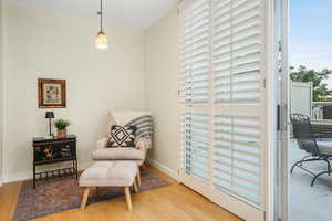 Living area with wood finished floors and baseboards