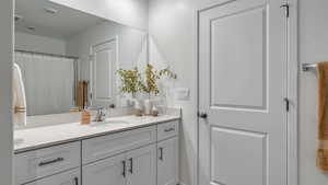 Full bath featuring vanity