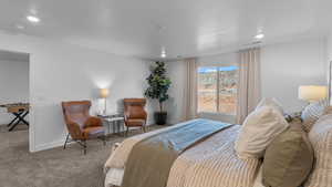 Bedroom featuring carpet flooring, recessed lighting, and a textured ceiling