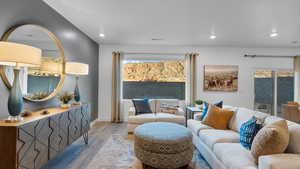 Living room featuring light wood finished floors and recessed lighting