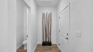 Corridor featuring wood finished floors and baseboards