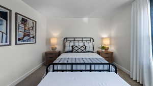 Bedroom with carpet floors and baseboards