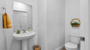 Half bath with toilet and baseboards