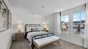 Carpeted bedroom with baseboards and a textured ceiling