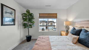 Carpeted bedroom with baseboards