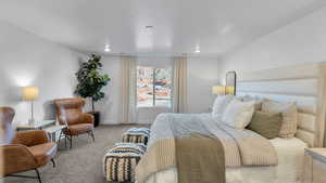 Bedroom featuring carpet and baseboards