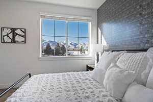 Bedroom with a mountain view and multiple windows