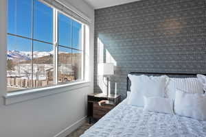 Carpeted bedroom featuring a mountain view and baseboards