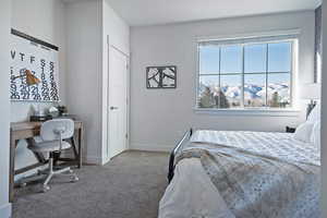 Bedroom with a mountain view, carpet flooring, and an office area