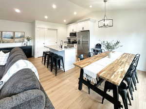 Dining area featuring recessed lighting, light wood-style floors, and lofted ceiling