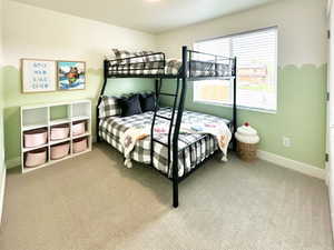 Carpeted bedroom featuring baseboards