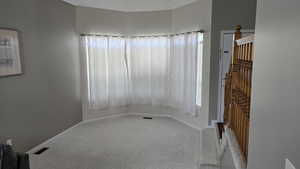 Spare room with carpet floors and plenty of natural light