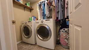 Laundry room featuring independent washer and dryer and tile patterned floors