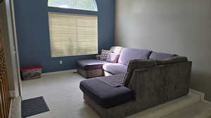 Carpeted living area with baseboards