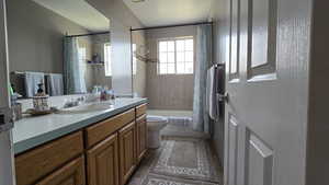 Bathroom with vanity and shower / tub combo