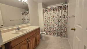 Full bathroom with vanity and curtained shower