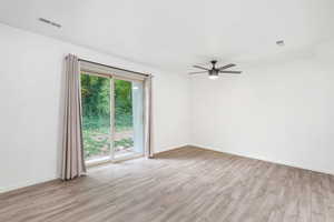 Unfurnished room featuring light wood finished floors and ceiling fan