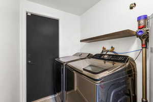 Laundry area with washer and clothes dryer