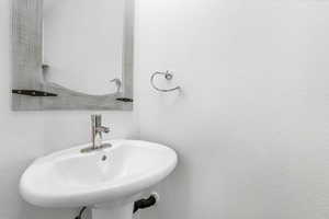 Bathroom featuring a sink and a textured wall