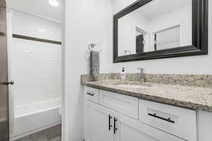 Full bath with vanity and tub / shower combination