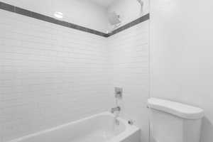 Bathroom with toilet and shower / bathtub combination