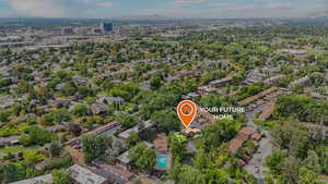 Aerial overview of property's location featuring nearby suburban area and a mountainous background