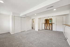 Below grade area with recessed lighting, carpet floors, and a textured ceiling