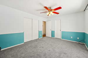 Unfurnished bedroom with carpet, ceiling fan, and a closet