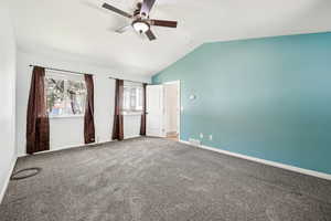 Unfurnished bedroom with lofted ceiling, carpet floors, and ceiling fan