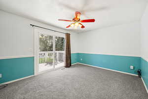 Carpeted empty room with a textured ceiling and ceiling fan