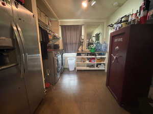 Kitchen with separate washer and dryer, fridge with ice dispenser, a textured ceiling, and dark wood-style floors