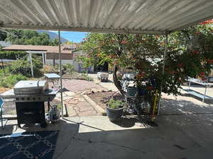 View of patio featuring a grill