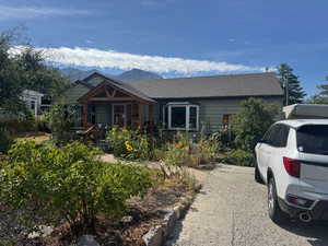 View of front of house with roof with shingles