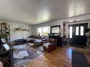 Living room with light wood-style flooring and a textured ceiling