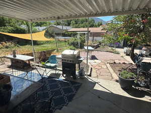View of patio featuring a grill and outdoor dining area